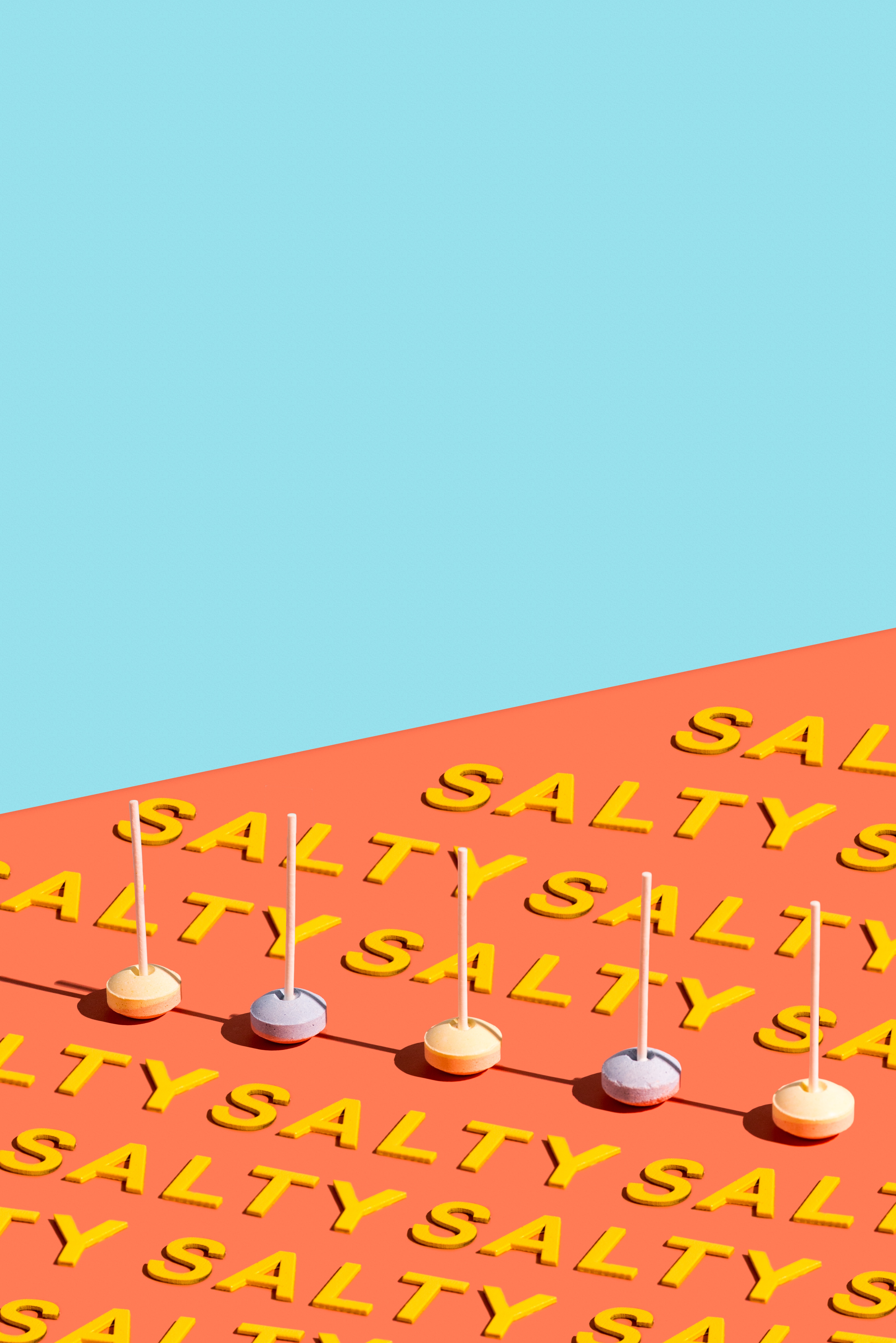 Orange background with the world 'salty' repeated on it and some candy. 