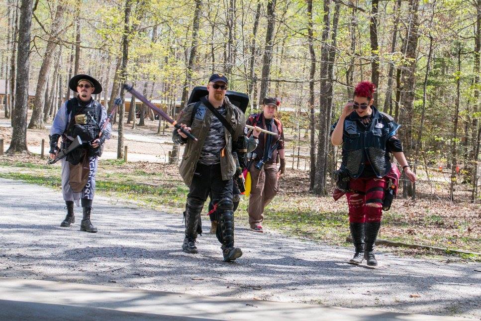 Four heavy hitters walk across a street.