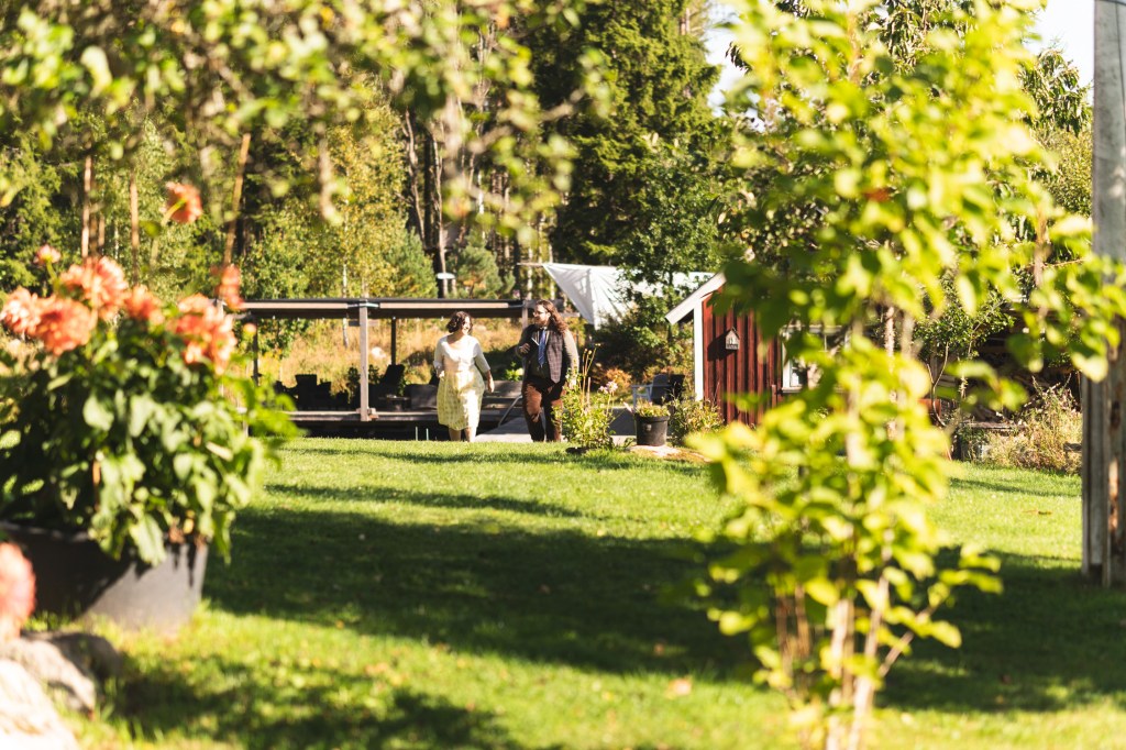 Two people walk under the sun.